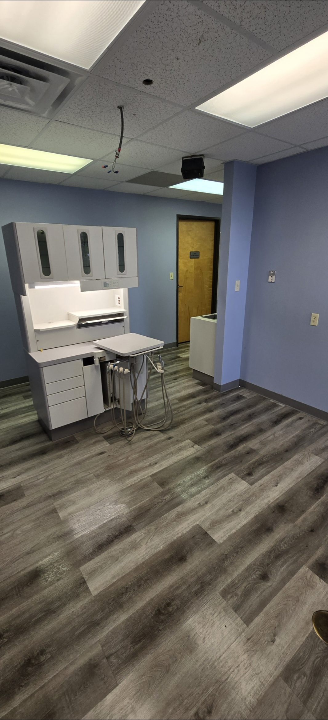 A cleared operatory after liquidation: equipment removed, floors clean, space ready for walkthrough