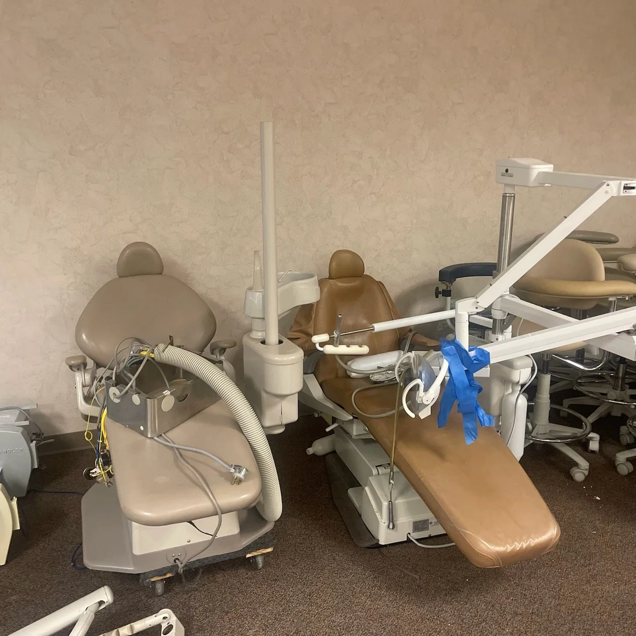 Dental chairs staged for removal during a Midwest office liquidation